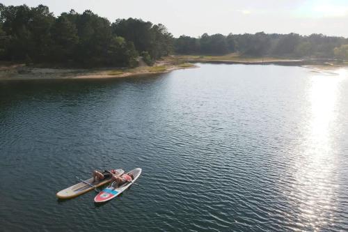 a person sitting on a kayak in the water at Private Lake and Hiking, The Loft at Haven in Cape May Court House
