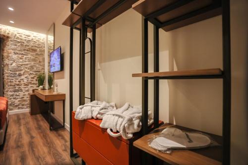 a room with a bunk bed with towels on it at NOMA Boutique Hotel in Shkodër