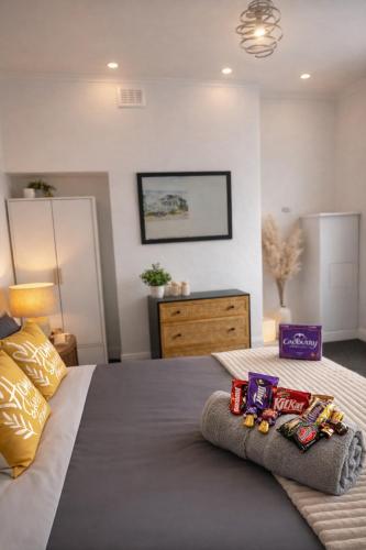 a bedroom with a bed with snacks on it at 2 bedroom Large House For Contractors, And Family with a sofa bed in Shildon