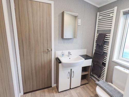 a bathroom with a sink and a toilet at Lily's Lodge in Morecambe