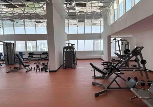 a gym with treadmills and exercise equipment in a building at Panoramic Sea & Skyline View Private Room in Sharjah