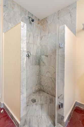 a shower with a glass door in a bathroom at Private villa, 6 bedrooms, 2 pools with views in Acapulco