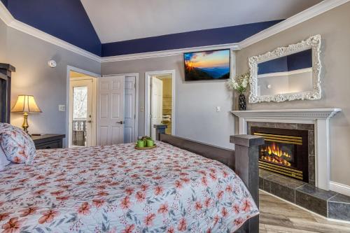a bedroom with a bed and a fireplace at Ober Hideaway, Hot Tub, WIFI, 560 FREE tickets each paid day!!! in Gatlinburg