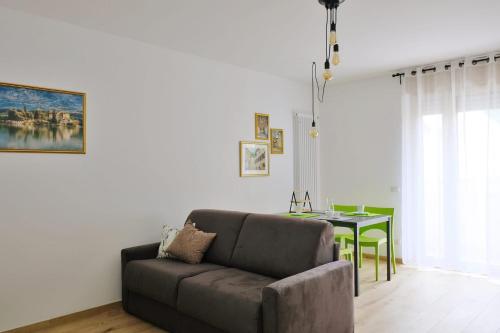 a living room with a couch and a table at I Castelli - Alle 5 Torri in Mezzolombardo