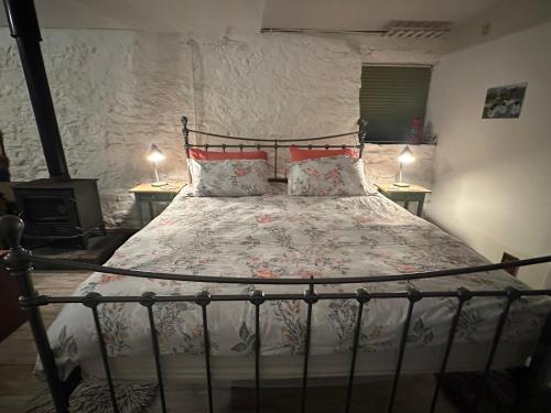 a bedroom with a bed with two tables and two lamps at The Milking Parlour in Collinstown