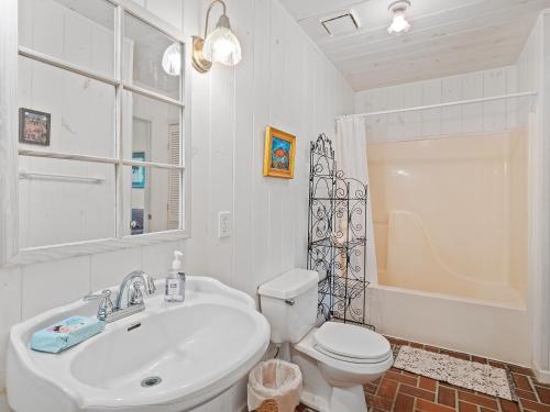 a bathroom with a sink and a toilet and a shower at Smith Lake Retreat - Close To Trident Marina in Crane Hill