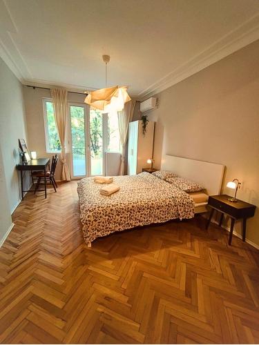 a bedroom with two beds and a wooden floor at Serenity and cosy Lodge, next to NDK! in Sofia
