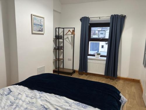 a bedroom with a bed and a window at Cheerful 3 Bedroom Townhouse in Bangor