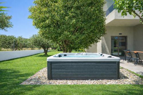a hot tub in the yard of a house at Luxury Villa Marian with Private Pool and Jacuzzi near the Beach of Georgioupoli in Georgioupolis