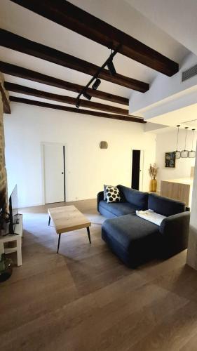 a living room with a blue couch and a table at Casa riera in Valderrobres