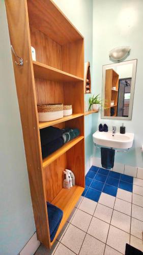 a bathroom with a sink and a toilet and a mirror at Muri Lagoon Cottage in Rarotonga
