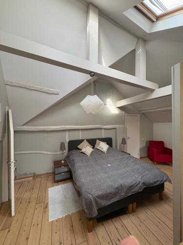 a bedroom with a large bed in an attic at Vakantiehuis Rosa in Ons Belang