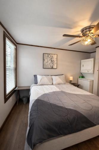 a bedroom with a bed and a ceiling fan at The Cozy Cow Cottage in Bluefield