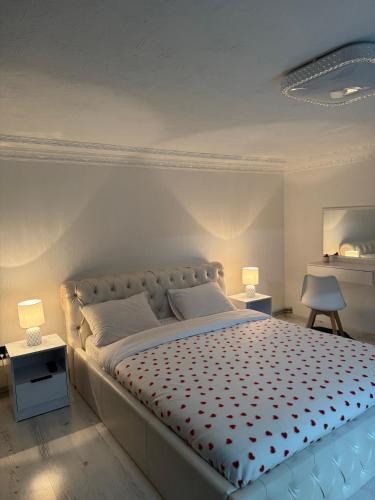 a bedroom with a large bed with two lamps at Fochyn House in Krivorovnya