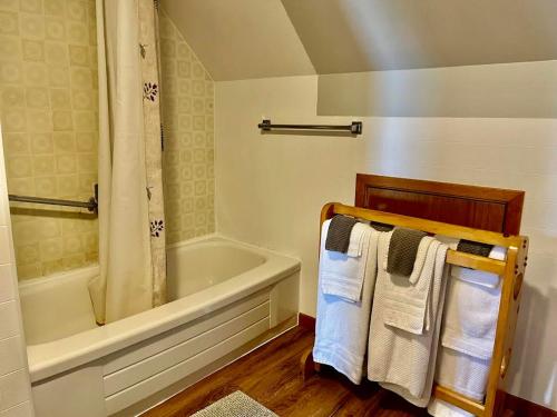 a bathroom with a tub and a towel rack at Hilltop Landing in Digby