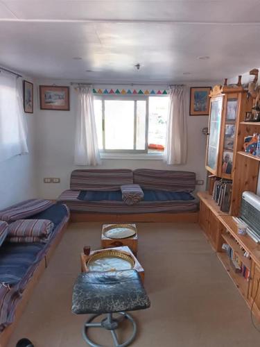 a room with two beds and a window at Shellaly Ca Nubian Heritage House in Jazīrat Salūjah