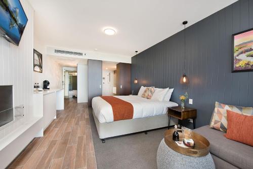 a hotel room with a bed and a couch at Altitude On Montville in Montville