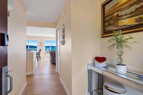 a hallway with a living room and a dining room at Beachbreeze Oceanfront 4BR1Den4BA Romantic Sunrise & Celestial Views in Mill Bay