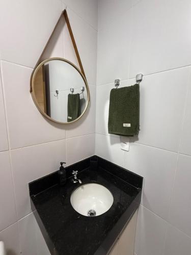 a bathroom with a black sink and a mirror at Loft Dominguinhos in Campina Grande