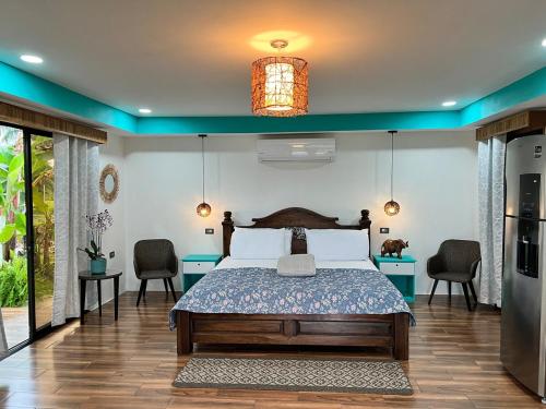 a bedroom with a bed and two tables and chairs at Sassy Sloth Villa in Fortuna