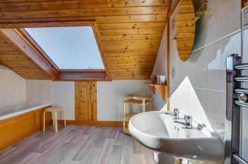 a bathroom with a sink and a window at 4 Bed in Moelfre oc-wai202 in Moelfre