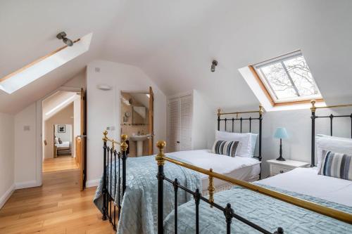 a bedroom with two beds and a skylight at 3 Bed in Corwen oc-fl009 in Derwen