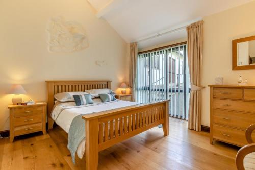 a bedroom with a bed and a large window at 2 Bed in Caersws oc-waa322 in Trefeglwys