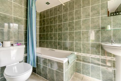 a bathroom with a toilet and a tub and a sink at 2 Bed in Caersws oc-waa322 in Trefeglwys
