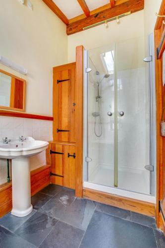 a bathroom with a shower and a sink at 3 Bed in Caernarfon oc-wag443 in Llanwnda