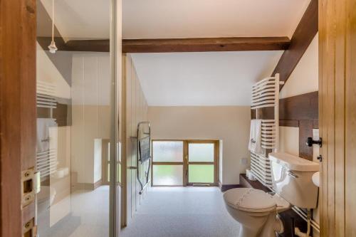 a bathroom with a toilet and a window at 4 Bed in Builth Wells oc-39473 in Builth Wells
