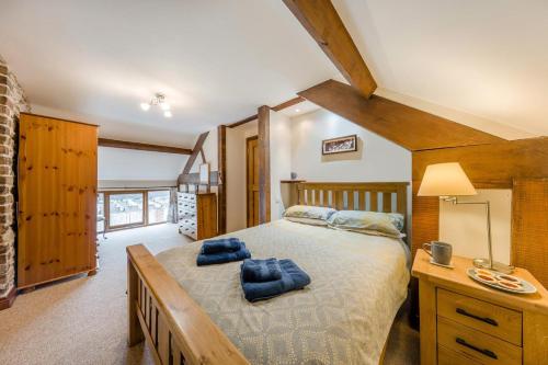 a bedroom with a bed with blue pillows on it at 4 Bed in Builth Wells oc-39473 in Builth Wells