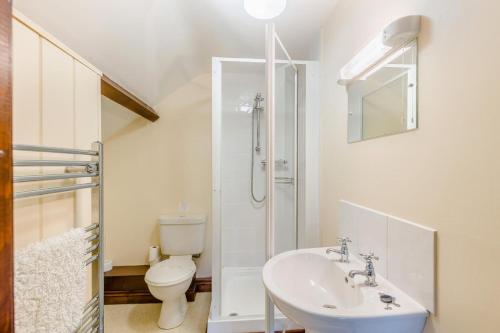 a white bathroom with a toilet and a sink at 4 Bed in Builth Wells oc-39461 in Builth Wells
