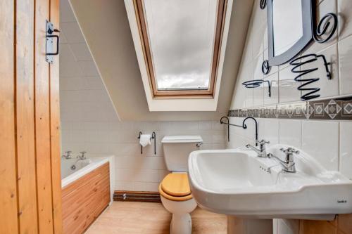 a bathroom with a sink and a toilet and a tub at 2 Bed in Welshpool oc-75703 in Meifod