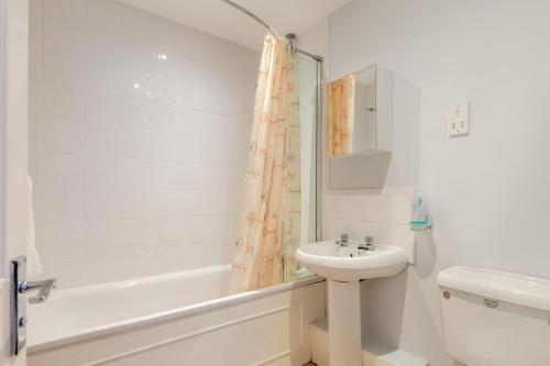 a white bathroom with a sink and a shower at 2 Bed in Charmouth oc-wy395 in Charmouth