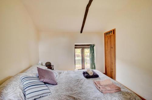 a bedroom with a bed with pillows and a window at 2 Bed in Brecon oc-37318 in Pentre-bâch