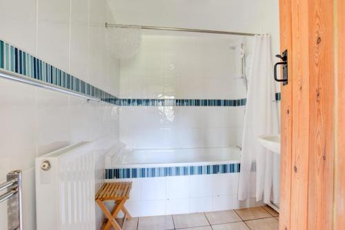 a white bathroom with a tub and a shower at 2 Bed in Brecon oc-37318 in Pentre-bâch