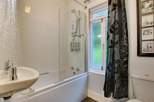 a white bathroom with a sink and a shower at 6 Bed in Dolgellau oc-wah675 in Arthog