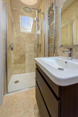 a bathroom with a sink and a shower at 3 Bed in Abersoch oc-9penyb in Abersoch