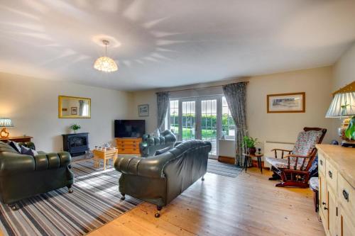 a living room with leather furniture and a fireplace at 2 Bed in Felindre oc-hh39 in Felindre