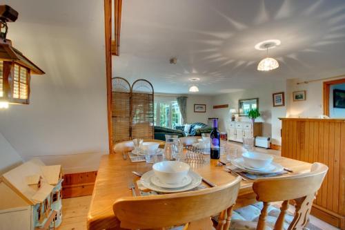 a dining room with a wooden table and chairs at 2 Bed in Felindre oc-hh39 in Felindre