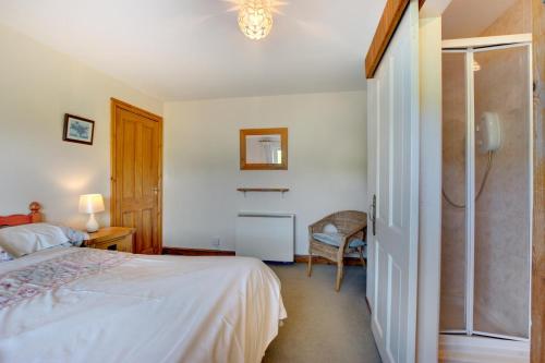 a bedroom with a bed and a walk in shower at 2 Bed in Felindre oc-hh39 in Felindre