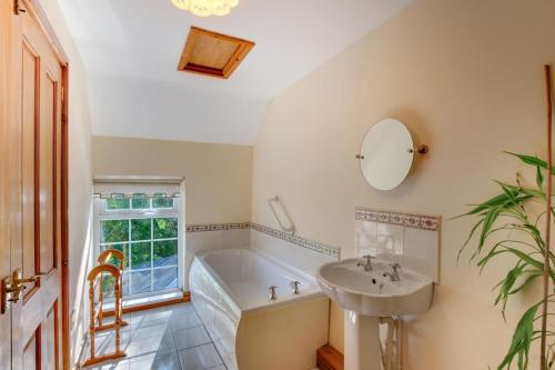 a bathroom with a bath tub and a sink at 2 Bed in Felindre oc-hh39 in Felindre