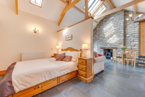 a bedroom with a large bed and a stone wall at 1 Bed in Gower oc-hh408 in Llanmadoc