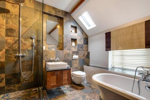 a bathroom with a sink toilet and a shower at 4 Bed in Gower oc-hh701 in Port-Eynon