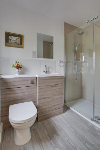 a bathroom with a toilet and a shower and a sink at 1 Bed in Frittenden oc-cb564 in Frittenden