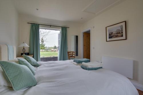 a large white bed in a room with a window at 1 Bed in Frittenden oc-cb564 in Frittenden
