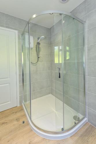 a shower with a glass enclosure in a bathroom at 3 Bed in Pwllheli oc-16glyn in Llanbedrog