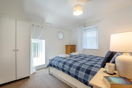 a bedroom with a bed and a table with a lamp at 2 Bed in Betws Y Coed oc-wag474 in Betws-y-coed