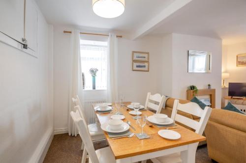 a dining room and living room with a table and chairs at 2 Bed in Betws Y Coed oc-wag474 in Betws-y-coed