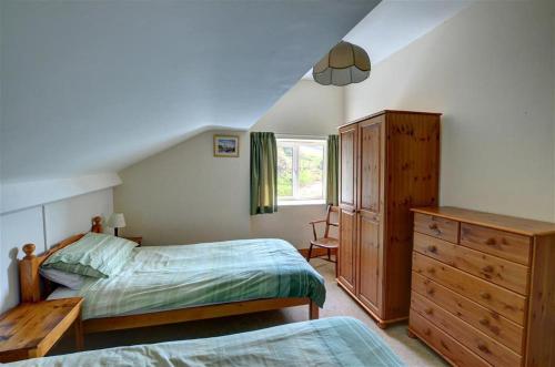 a bedroom with two beds and a dresser at 4 Bed in Presteigne oc-wak235 in Norton